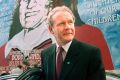 Martin McGuinness in front of a mural of Bobby Sands on the Falls Road in West Belfast in  2001. 