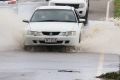 Cars drive through partially flooded roads in Bowen the day after Cyclone Debbie blew through.