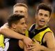 Up and about: Trent Cotchin and the Tigers celebrate after the skipper kicked a goal at the MCG.