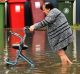 A woman evacuates her home near in central Lismore.