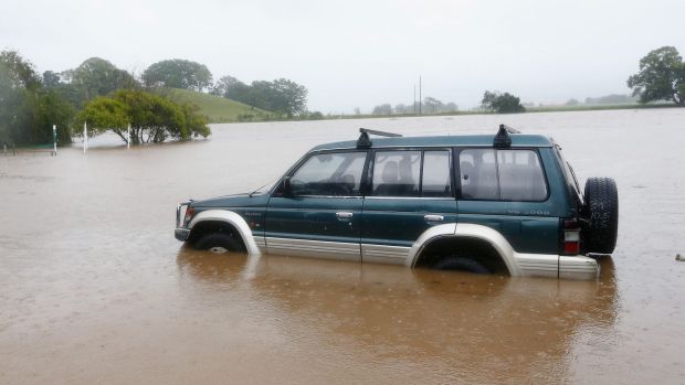 A car is trapped in the floods in Murwillumbah.