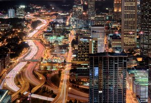 The Downtown Connector, seen at night in Midtown. Three major interstate highways converge in Atlanta; I-20 runs east to west across town, while I-75 runs from northwest to southeast, and I-85 runs from northeast to southwest.