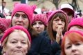 Women in "pussy hats" listen to speakers at the Women's March on Washington in January. 