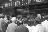 Crowds gather around a TV in the window of the Bank of New South Wales in Sydney to watch Neil Armstrong walk  on the ...