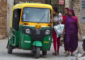 African women negotiate the price of a ride with a three wheeler in New Delhi, India, Wednesday, June 8, 2016. For thousands of Africans residing in India racism is a daily battle and simple everyday tasks like hiring an auto rickshaw or buying vegetables, every encounter with Indians is fraught. (AP Photo/Saurabh Das)