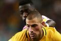 James Troisi is challenged by Ahmed Barman in the Socceroos' World Cup qualifier against the UAE.