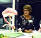 Cake decorating judge Janice Smith carefully inspects entries in the novice cake decorating class for the Royal Easter Show. 