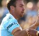 James Maloney (left) of the Sharks celebrates kicking a field goal.