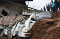 Rescuers inspect the damage of a landslide in the village of Banaran, Ponorogo, East Java, Indonesia.