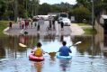 Michael and Caleb Eadie made the most of the flooding at Kokoda Street, Beenleigh.