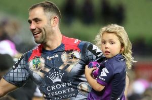 Cameron Smith, with daughter Matilda, celebrates with Storm fans.