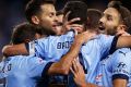 Momentum: Alex Brosque of Sydney FC celebrates with teammates after scoring the opening goal.