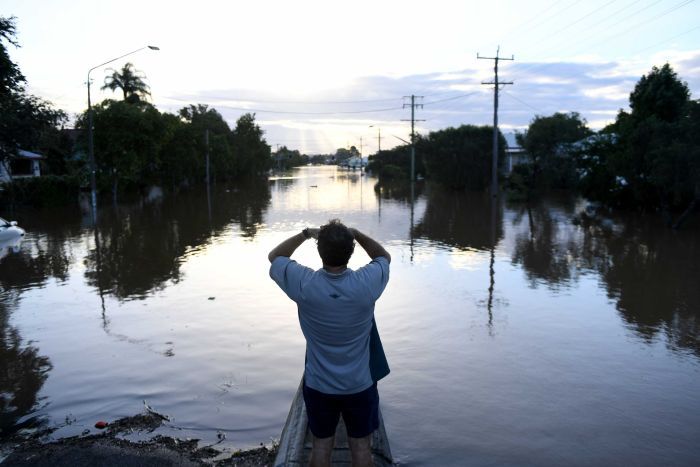 Residents watch the flood waters in Lismore, New South Wales, Friday, March 31, 2017.