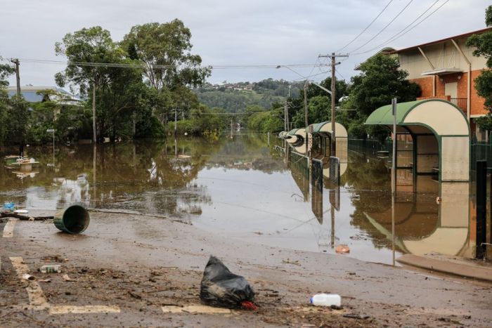 Rubbish on a road, with water. 