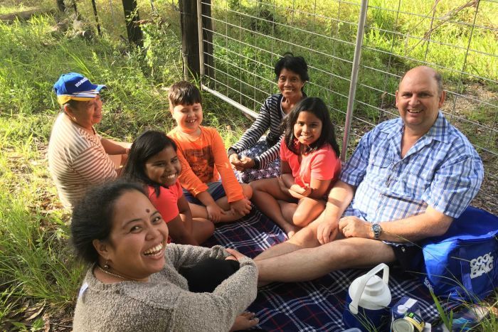 A family waits for the Pacific Highway to reopen