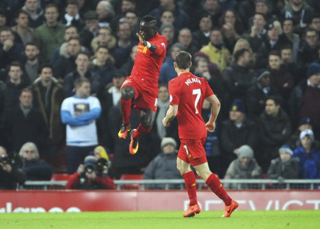 Liverpool’s Sadio Mane, left, celebrates scoring his sides first goal during the English Premier League soccer match between Liverpool and Tottenham Hotspur at Anfield, Liverpool, England