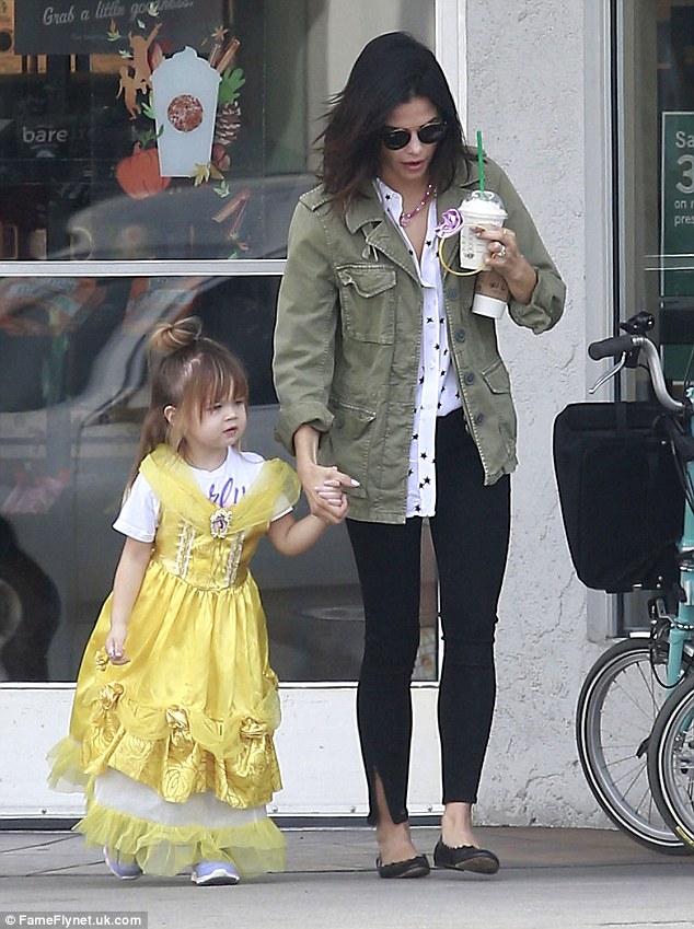 Doting mom: The star headed out through the parking lot hand-in-hand with her little girl, who must have been having a blast dressed  in the official Disney Princess Belle costume