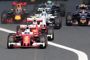 Vettel's Ferrari leads the field into turn one to get the procession under way.