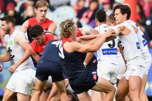 Melbourne and Carlton players wrestle during the round two match on Sunday which resulted in suspensions for Jesse Hogan ...