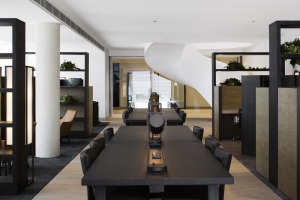 One of the common area, with sculptural, sweeping staircase, in the background, at the Little National Hotel, Canberra.