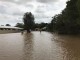 People attempt to wade through floodwaters in Chinderah (Image:AAP)