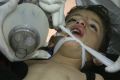 This photo provided by the Edlib Media Center, which has been authenticated, shows Syrian doctors treating a child ...