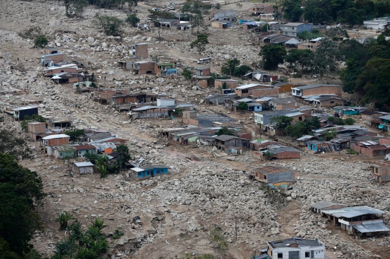 Boulders and debris surround homes damaged when rivers surrounding Mocoa overflowed and sent a wall of water and debris ...