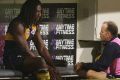 The Eagles' Nic Naitanui holds his injured knee on the bench during the match against Hawthorn on Friday night. 