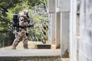 File - Marine Corps Cpl. Joshua Hatfield uses a Multirae device to detect simulated biological contamination in Combat Town, Okinawa, Japan, March 21, 2017. Hatfiled is a member of the 3rd Marine Division's Chemical, Biological, Radiological and Nuclear Platoon response element.