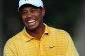 Tiger Woods laughs with Richard Green of Australia during a practice round prior to the start of the 89th PGA ...