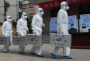 Medical workers in China take part in a drill that simulates human infection of an avian influenza virus, after an ...