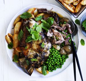 Slow-roasted lamb with tarragon, peas and crispy potatoes.