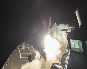 The guided-missile destroyer USS Ross fires a tomahawk land attack missile targetting Syria, April 7, 2017.