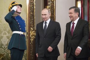 Visiting Uzbek President Shavkat Mirziyoyev, right, and Russian President Vladimir Putin, center, enter a hall for talks in Moscow's Kremlin, Russia, Wednesday, April 5, 2017.