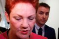 Senator Pauline Hanson and her adviser James Ashby depart the press gallery after an interview, at Parliament House in ...