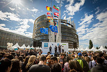 European Parliament opening in Strasbourg with crowd and many countries' flags on flagpoles