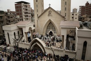 People gather outside the St. George's Church after a deadly suicide bombing, in the Nile Delta town of Tanta, Egypt, Sunday, April 9, 2017.