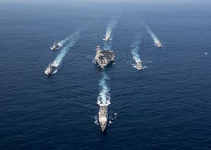 File - The Nimitz-class aircraft carrier USS Carl Vinson (CVN 70), the Arleigh Burke-class guided-missile destroyer USS Wayne E. Meyer (DDG 108) and the Ticonderoga-class guided-missile cruiser USS Lake Champlain (CG 57) participate in a photo exercise with Japan Maritime Self-Defense Force destroyers, Philippines Sea, 28 March, 2017.