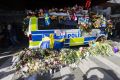 Flowers are left on a police car to show their gratitude to law enforcement officers after a peace demonstration on ...