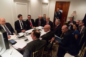 Donald Trump receives a briefing on a military strike on Syria from his National Security team