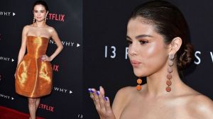 Selena Gomez looks shiny yet stylish in this orange Oscar de la Renta cocktail dress. It's very pretty and all, but it's ...