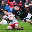 Within reach: Derry’s Benny Heron battles with Armagh’s Ciaran Higgins during the Dr McKenna Cup clash