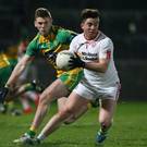 On the ball: Tyrone ace Ronan O’Neill gets away from Eoghan Ban Gallagher of Donegal