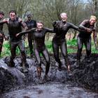 A group of runners jump in to a mud hole as competitors take part in the annual McVities Mud Madness 8km cross country run on April 9, 2017 in Portadown, Northern Ireland. The two lap race over twenty five obstacles is in aid of the Marie Curie charity. (Photo by Charles McQuillan/Getty Images)