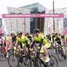 Cyclists pass the Titanic Building at the start of the Gran Fondo Giro d’Italia yesterday