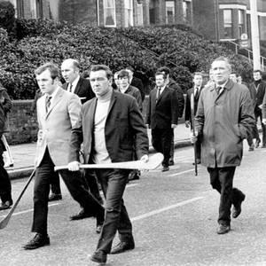 MOURNERS CARRYING HURLING STICKS HEAD THE FUNERAL PROCESSION OF JOHN JOSEPH KAVANAGH, FOUND SHOT DEAD IN THE RIVER BLACKSTAFF. 27.01.1971.