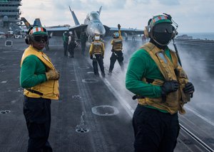 Sailors conduct flight operations on the aircraft carrier USS Carl Vinson flight deck, South China Sea, 8 April, 2017.