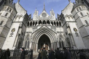 Media gather outside the High Court in London, Thursday Nov. 3, 2016 as they wait for the decision on the challenge to plans for Brexit.