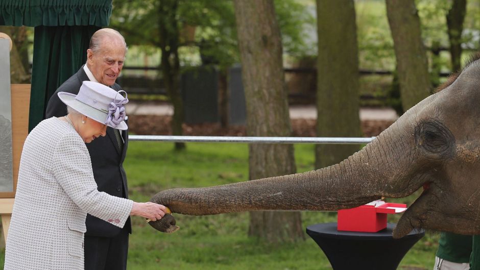 Britain's Queen Elizabeth II and her husband the Duke of Edinburgh are greeted by an elephant at the Zoological Society ...