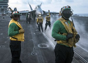 In this photo provided by the U.S. Navy, sailors conduct flight operations on the aircraft carrier USS Carl Vinson (CVN 70) flight deck in April 8, 2017.